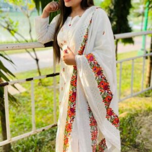 white base contrasted with vibrant, multi colored floral embroidery